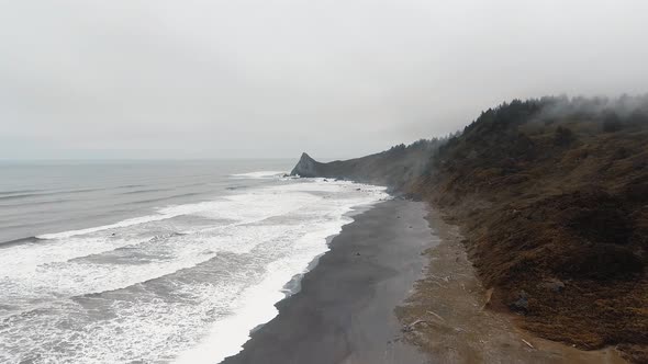 Bird's-eye view of Sharp Point mountain, ocean waves,shore in Dry Lagoon State Park, California, USA