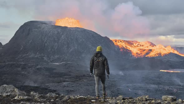 Man Walking Towards Erupting Fagradalsfjall Volcano In Reykjanes Peninsula