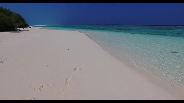 Aerial view scenery of marine seashore beach voyage by blue sea and bright sandy background of a day