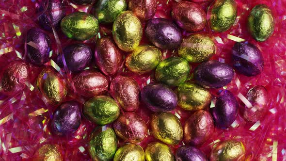 Rotating shot of colorful Easter candies on a bed of easter grass - EASTER