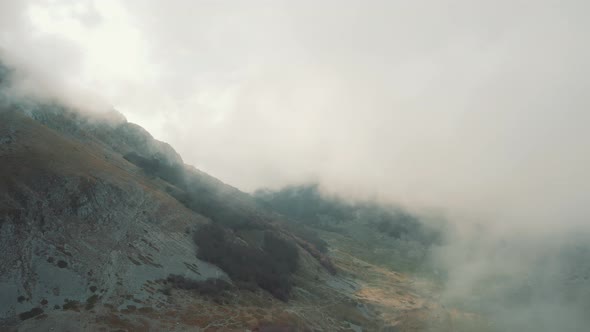 Aerial view of foggy, misty mountains - Flying through the clouds