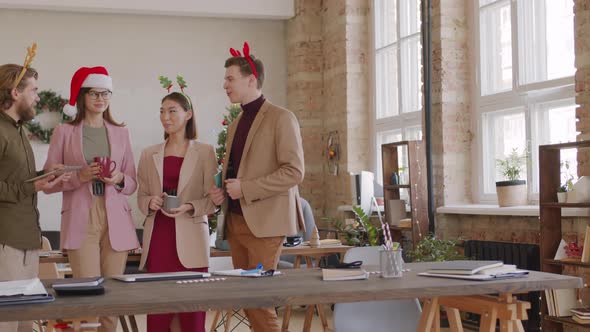 Portrait of Business Colleagues Chatting in Office on Christmas