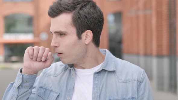 Sick Young Man Coughing Outdoor