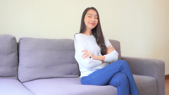 Asian woman sit on sofa and relax