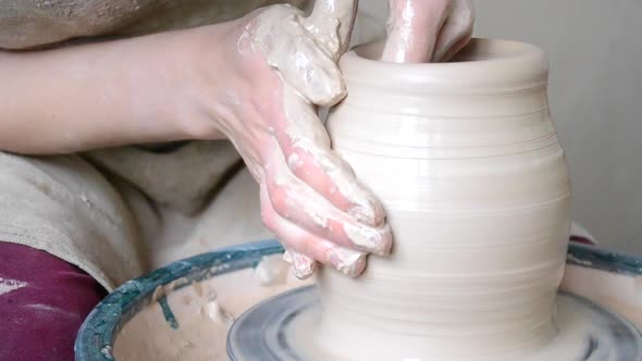Woman Forms the Shape of a Jug of White Clay
