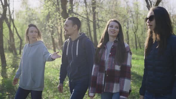 A Group of Young Successful and Beautiful People are Walking in the Park