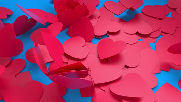 Red paper hearts fall to the floor