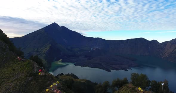 Aerial Panoramic View of Camping at High Altitude on Mount Rinjani Flying Backwards