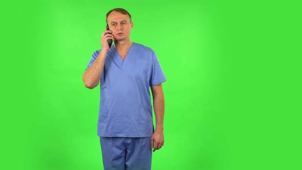 Medical Man Angrily Speaks on the Phone, Proves Something. Green Screen