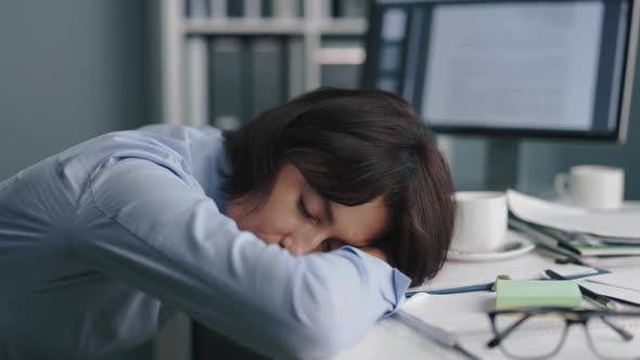 Female Worker Sleeping at Office