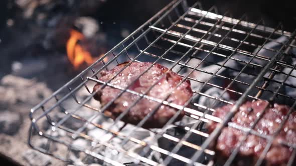 Beef Burgers Cutlets are Roasting on the Charcoal Barbecue Grill