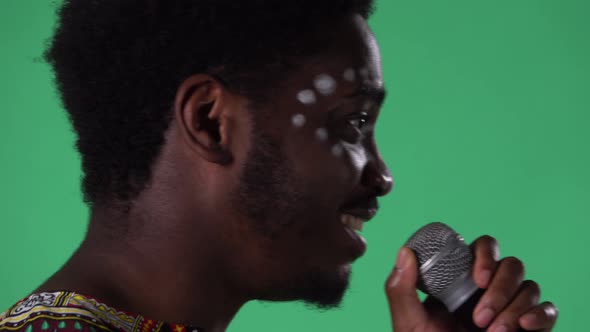 Portrait of Young African American Man Singing Song Into the Microphone