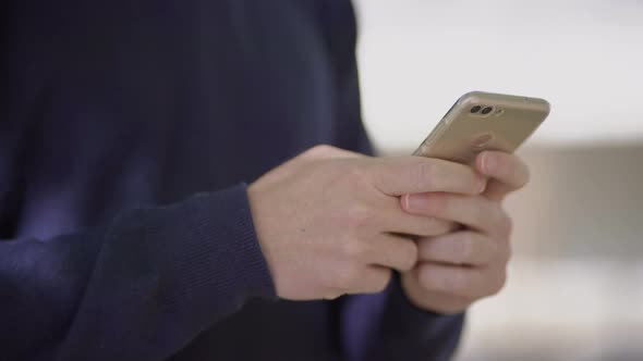 Cropped Shot of Man Using Cell Phone