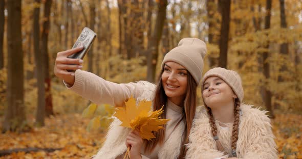 Mother and Daughter Doing Selfie in Autumn