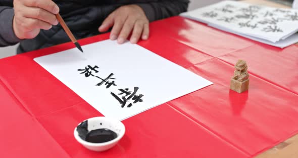 Man Write Chinese Calligraphy for Lunar New Year