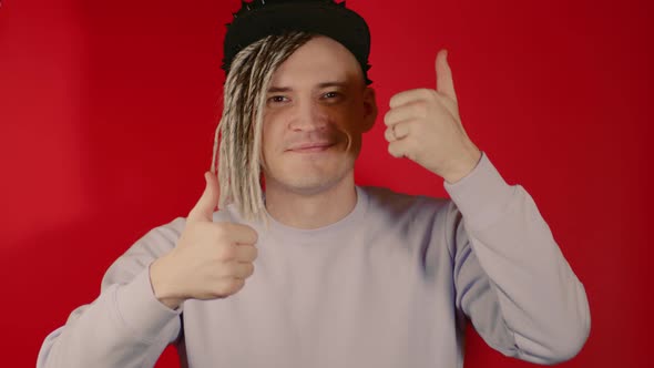 Young Handsome Man in Black Cap Showing Thumbs Up Looking at Camera