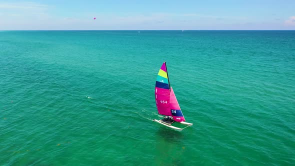 A colorful catamaran sailing the coastline in Florida