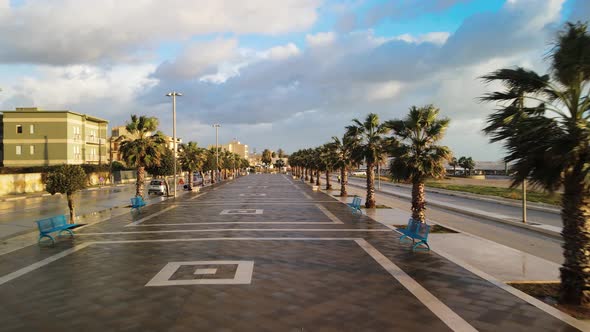 Aerial View of City Promenade Along the Ocean Beautiful Coast at Sunset From Drone