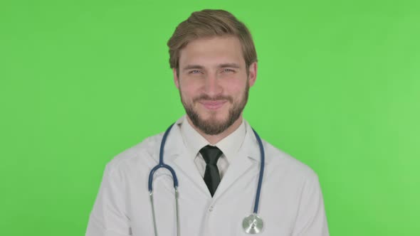 Approval By Young Doctor Shaking Head on Green Background