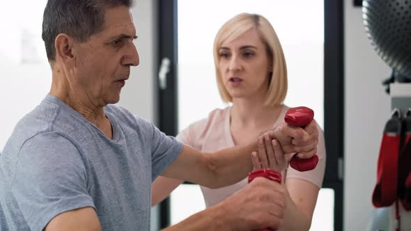 Caucasian senior man working with therapist. Shot with RED helium camera in 8K.