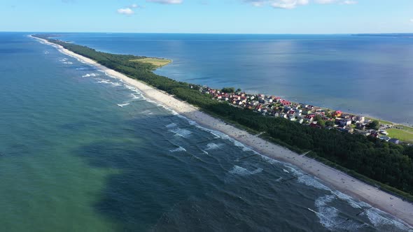 Beach in beautiful city Chalupy resort in Poland. Aerial video. Baltic Sea.Waves coming in.