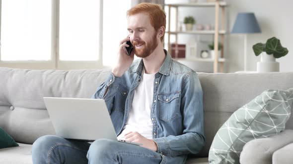 Man Talking on Phone with Customer in Office