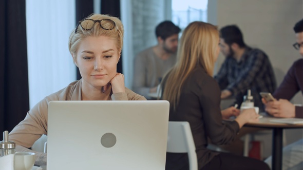 Portrait of Smiling Pretty Young Business Woman Putting