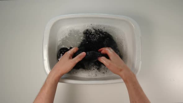 Young Adult Man Hand Wash A Clothes In A Pelvis