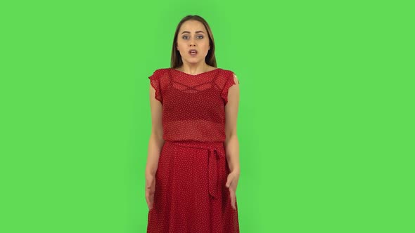 Tender Girl in Red Dress Is Upset, Waving Her Hands in Indignation, Shrugging. Green Screen