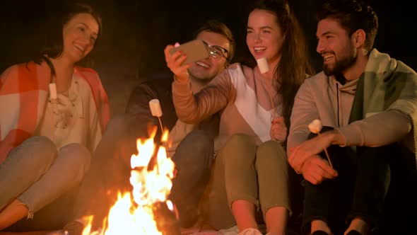 Friends Taking Selfie at Night Camp Fire