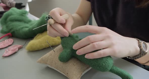 Woman Making Wool Art Doll Toy at Table Close Up. Female Sitting and Creating Ooak Doll at Home