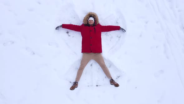 Man Top View Making Snow Angel