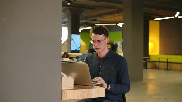 Sexy Attractive Male Wearing Glasses Typing Something on Laptop