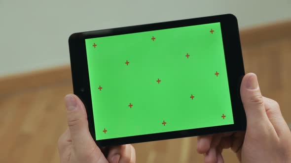 Male Hands Holding Tablet. Close Up Man Tapping Tablet Green Screen Tablet