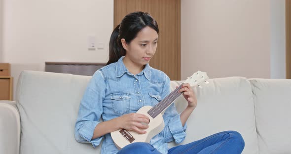 Woman Play with Ukulele at Home