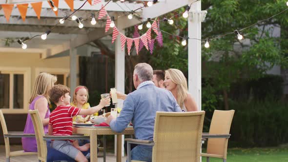 Three generation family enjoying lunch outdoors