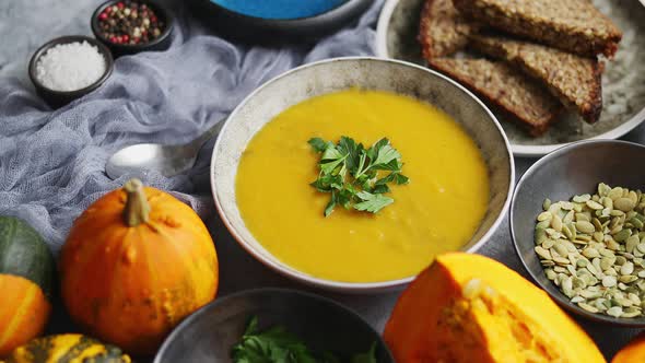 Pumpkin Puree Isoup in Bowl Over Rusty Stone Background