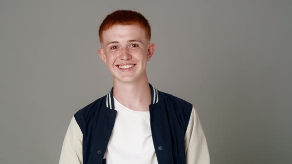 Portrait of red head caucasian teenage man with toothy smile. Shot with RED helium camera in 8K.