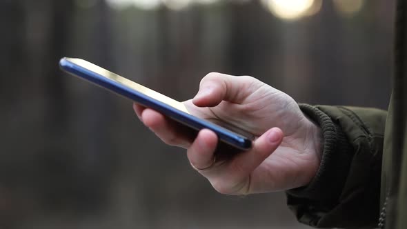 Close-up hand is typing on phone