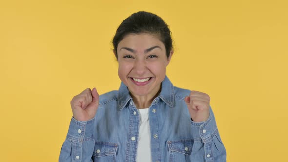 Excited Indian Woman Celebrating, Yellow Background 