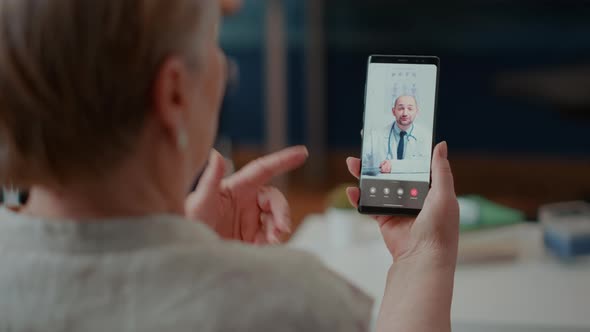 Retired Woman Attending Online Consultation on Videocall with Medic