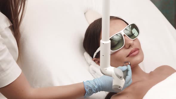 Pretty Girl in Beauty Clinic Having Laser Theraphy