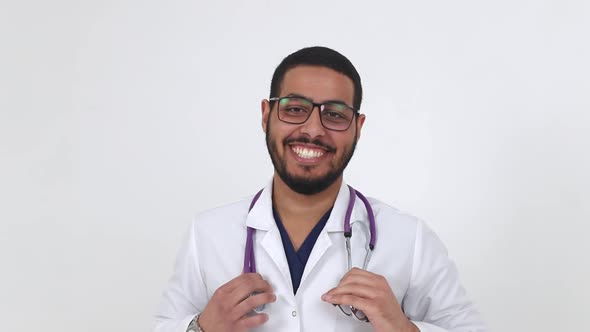 The doctor is Egyptian. Young doctor with glasses on a white background.