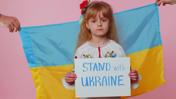 Sad Toddler Ukrainian Girl Kid in Embroidery Protesting War Conflict Raises Banner with Inscription