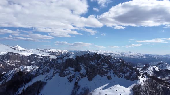 Aerial drone view of difficult access mountain peak for climbers during a winter sunny day