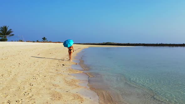 Women best friends on exotic lagoon beach voyage by blue sea with white sandy background of Koh Phan