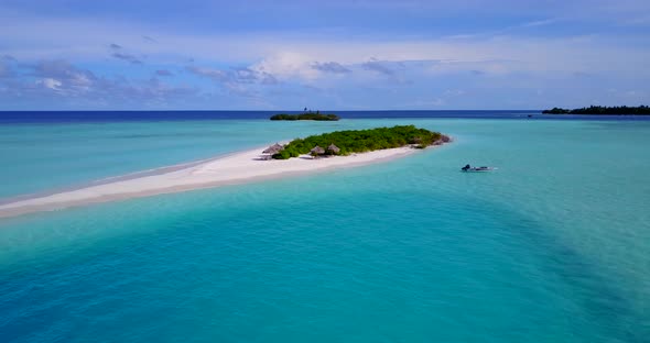 Tropical drone tourism shot of a white paradise beach and aqua blue ocean background in hi res 4K