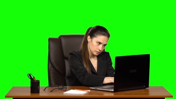 Stressed Female Enthusiastically Works Behind a Laptop and Very Angry. Green Screen