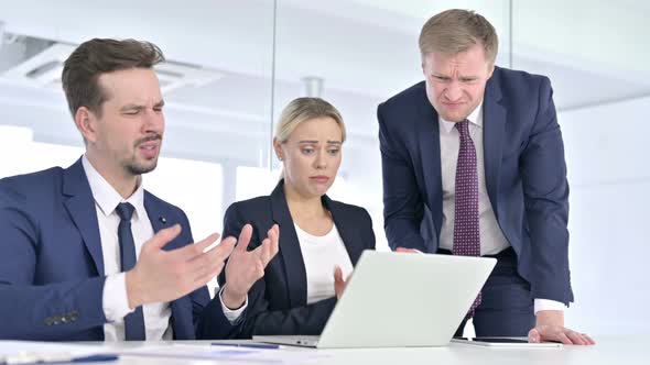 Disappointed Business Team Reacting To Failure on Laptop 