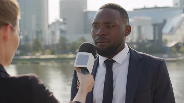 Afro-American Man Giving Interview Outdoors